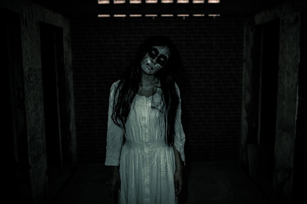 Portrait of asian woman make up ghost faceHorror sceneScary backgroundHalloween poster
