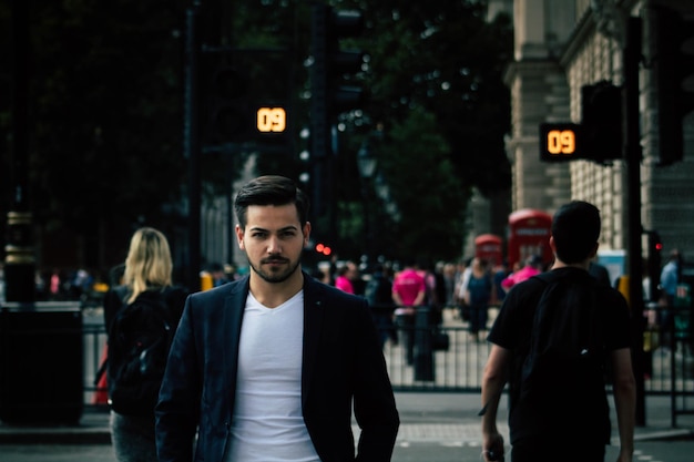 portrait of businessman standing on street in city