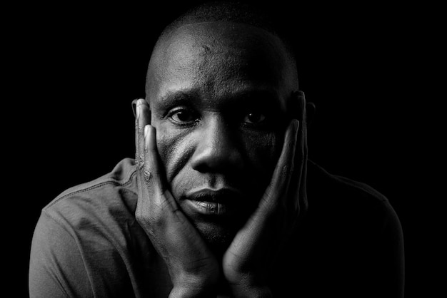 portrait of man against black background