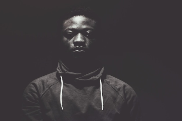 portrait of man against black background