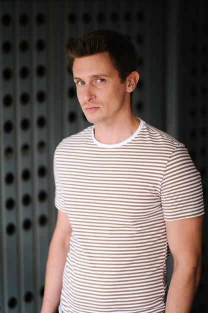 portrait of man standing against wall