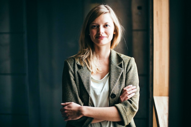 portrait of mid adult woman smiling by window