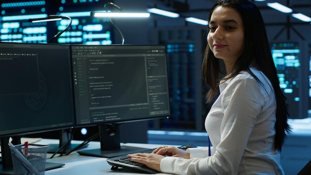 portrait of smiling engineer overseeing data center