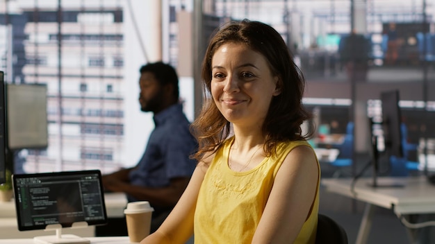 Portrait of smiling programmer creating machine learning models that can process and analyze data to