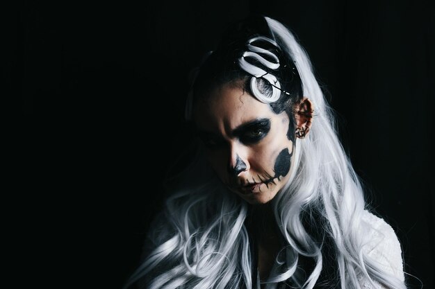 portrait of woman against black background