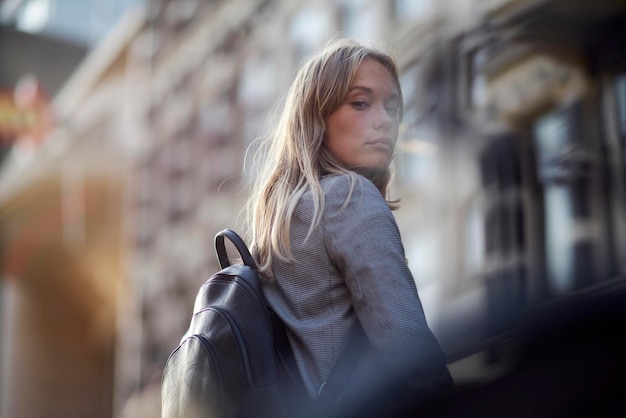 portrait of woman standing against buildings