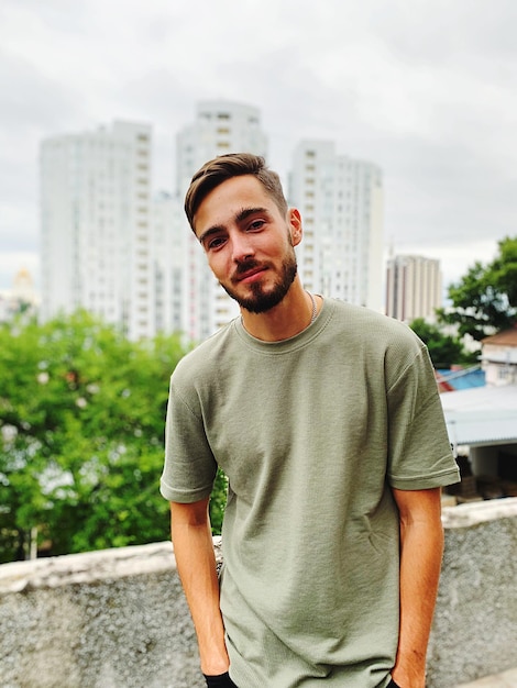 portrait of young man standing in city