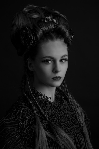 portrait of young woman against black background
