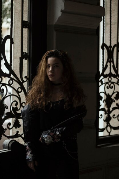 portrait of young woman standing at home