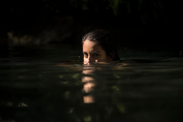 portrait of young woman swimming in lake