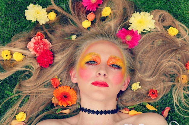 portrait of young woman with multi colored flowers