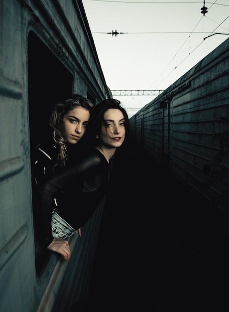 portrait of young women peeking out from train window