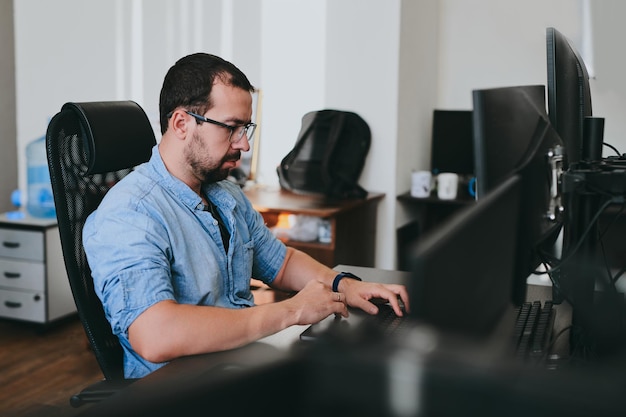 portrait professional man programmer working concentrated on computer in diverse offices modern it technologies development artificial intelligence programs applications and video games concept