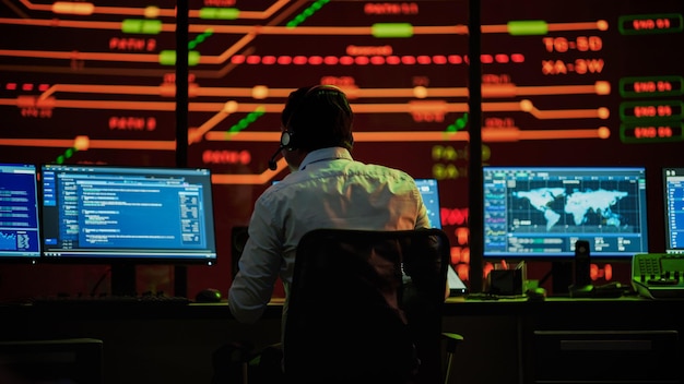 Professional IT Technical Support Specialists and Software Developer Working on Computers in Monitoring Control Room with Digital Screens with Server Data Blockchain Network and Surveillance Maps