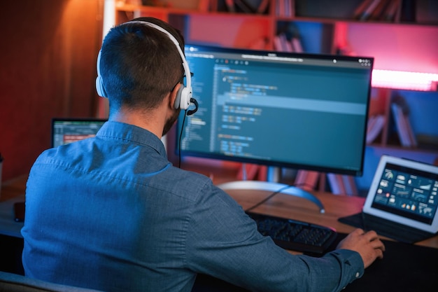 Professional programmer is working indoors Neon lighting