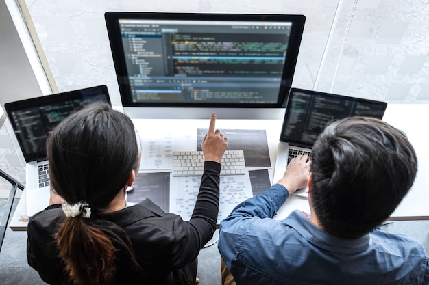 Professional Team of programmer working on project in software development computer in IT company office, Writing codes and data code website and coding database technologies on new Application.