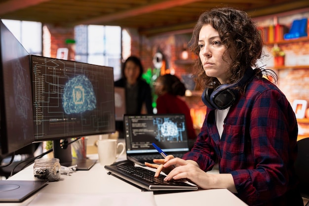 Programmer coding in fast paced AI startup office building scalable solutions