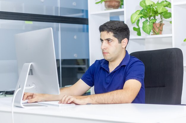 programmer coding with computer person doing work in office