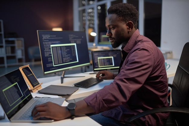 Programmer concentrating on his online work on computers