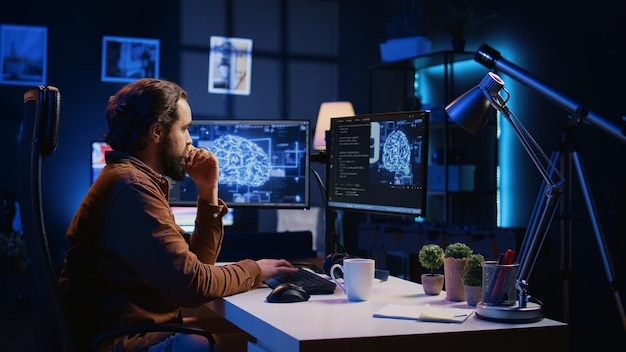 Programmer using computer to update AI neural networks drinking coffee
