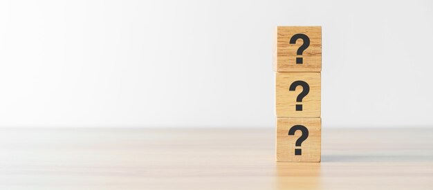 Questions Mark word with wood block on table background FAQ frequency asked questions Answer Q and A Information Communication questionnaire and Brainstorming Concepts