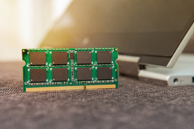 ram memory cards for notebook. random access memory for replacement to laptop computer. ram module ddr in hand on the background of a modern notebook-transformer. ultrabook upgrade