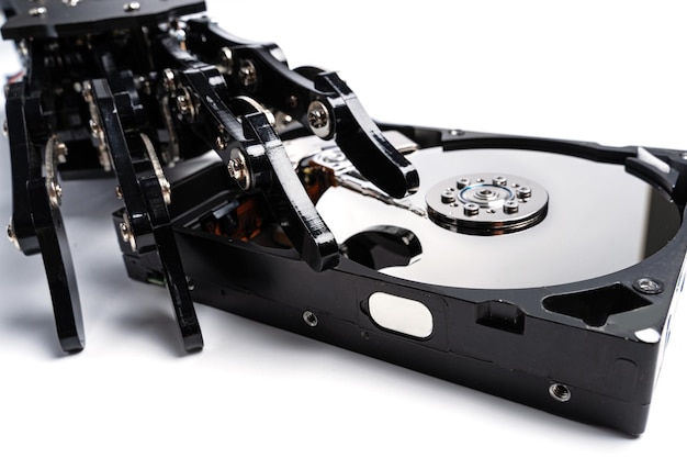 Real robotic hand with Hard disk drive Concepts of AIpowered data protection or machine learning