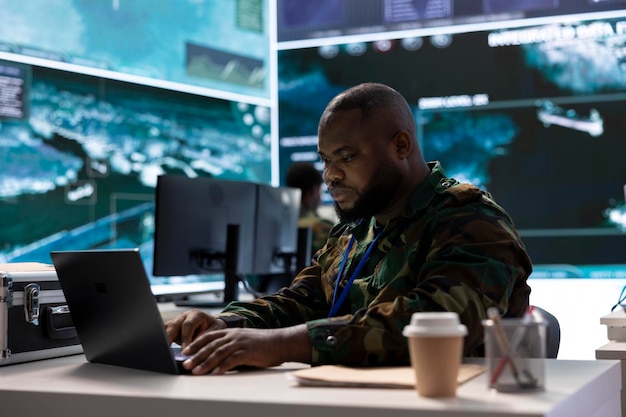 secret service agent in an advanced control room handles surveillance activity