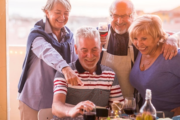 senior couple in balcony during social gathering