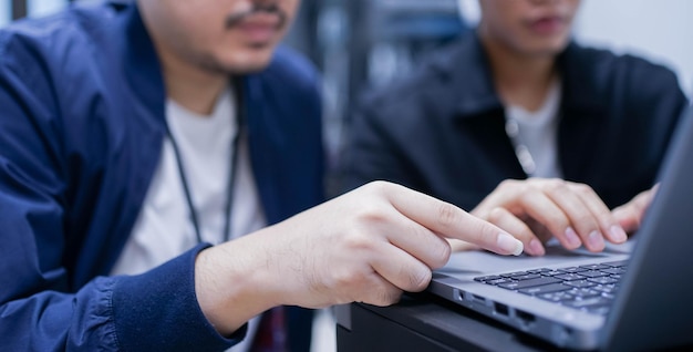 senior programmer teach employee trainee on  to input code language into software system