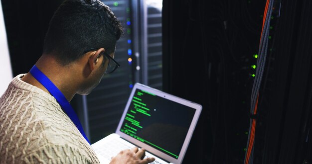 Server room laptop and screen for coding cybersecurity update or online machine system IT support data center and technician man or engineer for network information technology and solution