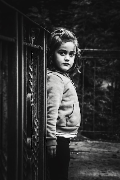 side view portrait of girl standing against railing