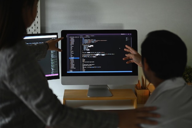 Skilled software developer team programming code on the computer for cyber security