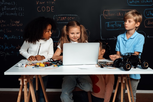 Smart girl in white bib learning robotics technology using laptop Erudition