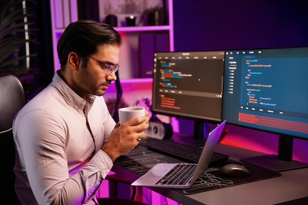 smart it developer drinking coffee cup while working code on pc screen surmise