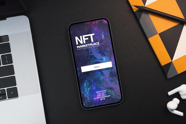 smartphone with nft nonfungible token marketplace on the screen on black background table office environment crypto art