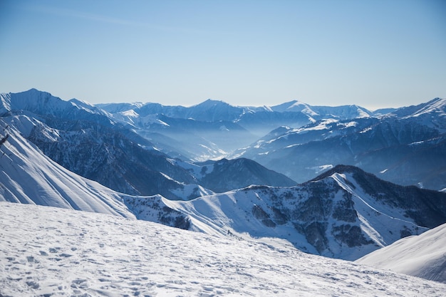 Snow covered landscape against clear sky