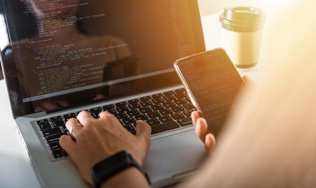Software developer hands typing data coding programming javascript with laptop computer