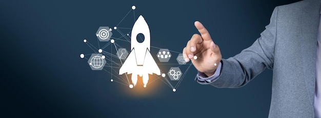 Startup concept Businessman touching icon transparent rocket is launching
