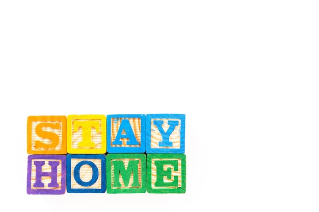 stay home sign out of kids' alphabet blocks on a white background.