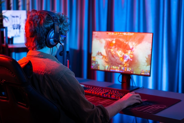 Streamer playing fighting Moba wearing headphone and mic Gusher