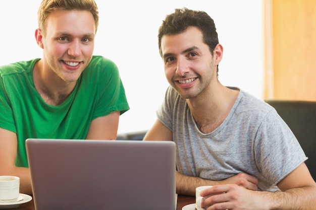 Students using laptop while having coffee at  coffee shop