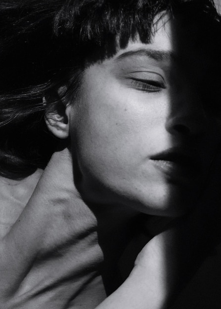 sunlight falling on woman face in darkroom