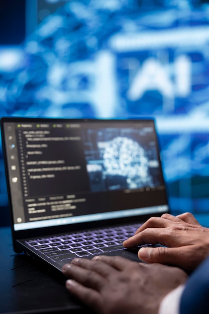 system administrator analyzing complex ai brain models on laptop close up