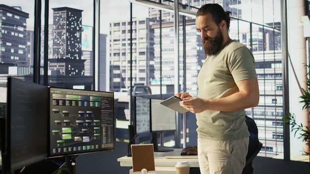 System administrator checking machine learning results on tablet