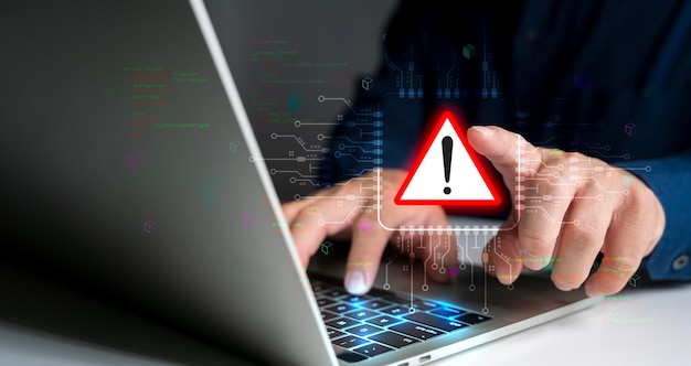 system hacked warning alert person use laptop with virtual warning sign for cyber attack