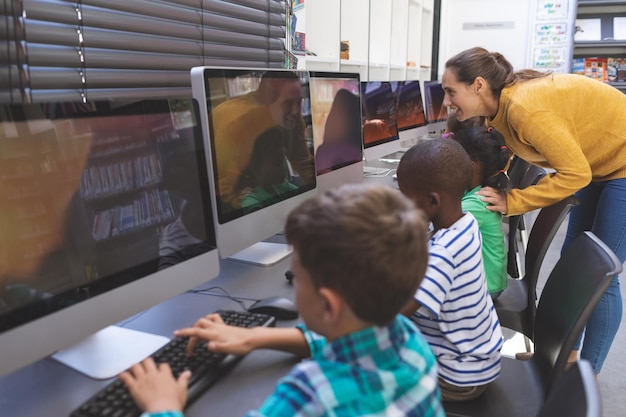 Teacher teaching student in computer room