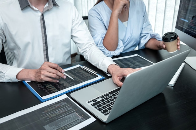 Team of Developer programmer working on coding program software computer in office, Writing website and development database technology.