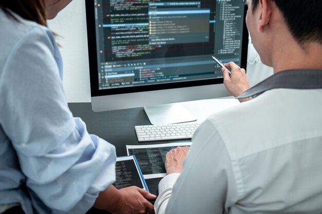Team of Developer programmer working on coding program software computer in office