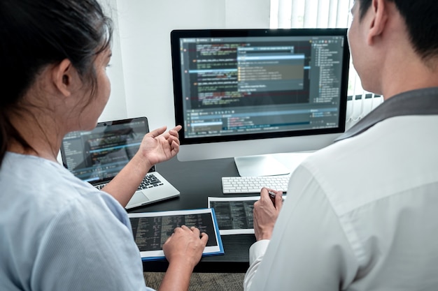 Team of Developer programmer working on coding program software computer in office